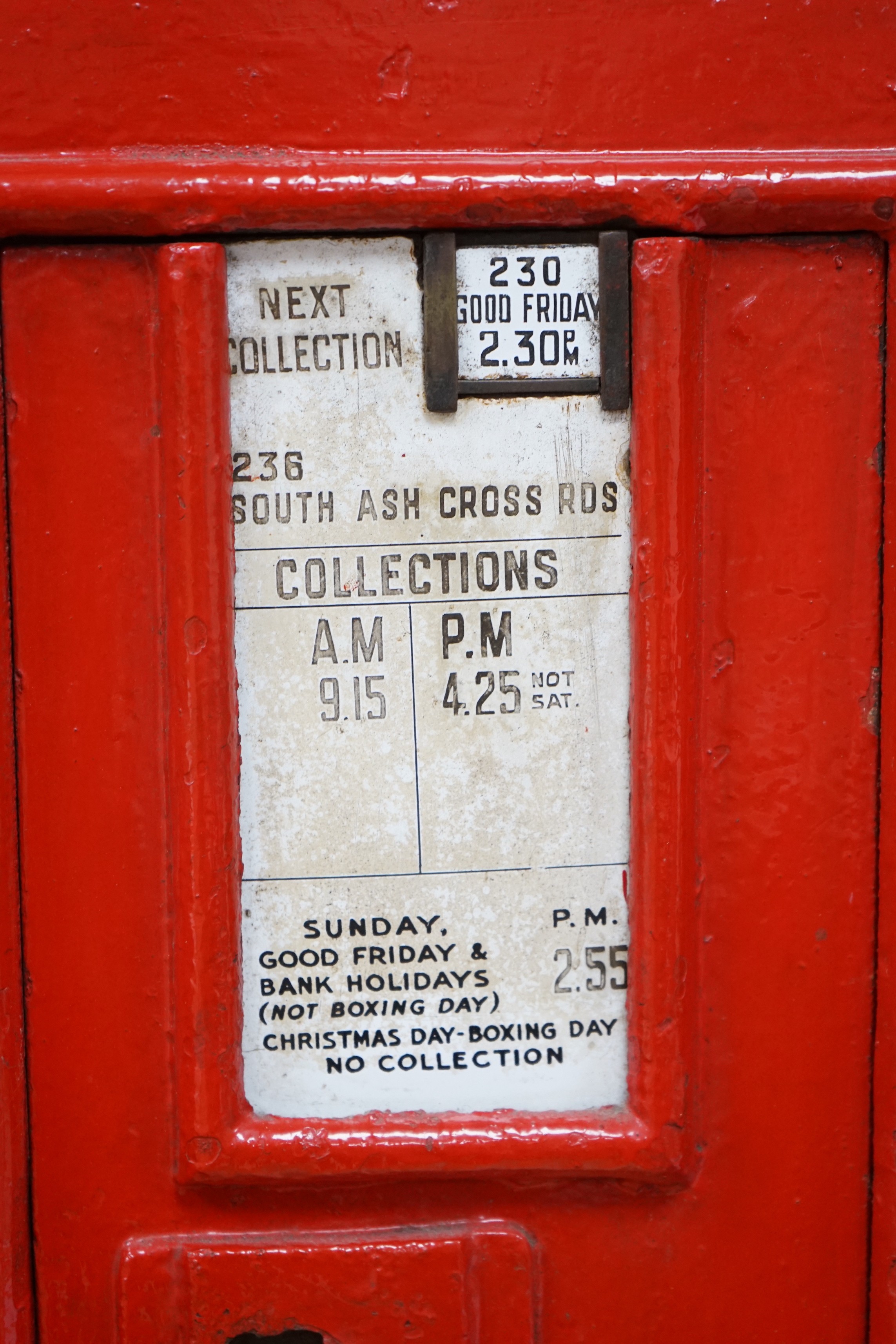 A Victorian red painted cast iron wall mounted post box, 72cm tall